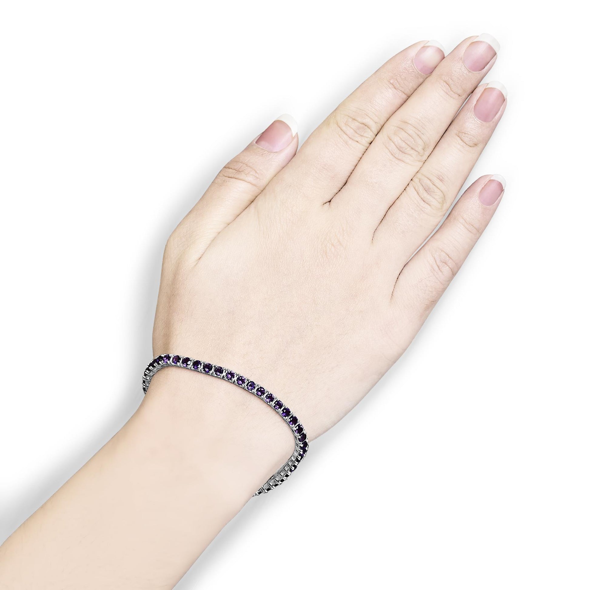 White metal bracelet with round purple gemstones in 4-prong settings, shown on a model's wrist from a top angle.