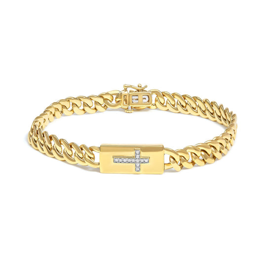 Yellow metal bracelet with chain links and a rectangular plate featuring a cross design set with white round gemstones, shown from a front angle.