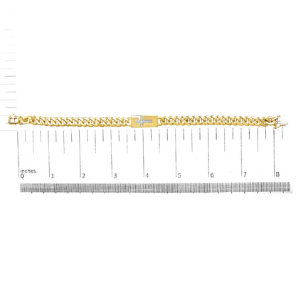 Yellow bracelet with a cross-shaped accent set with white round gemstones, displayed flat on a ruler for size reference, top-down angle.