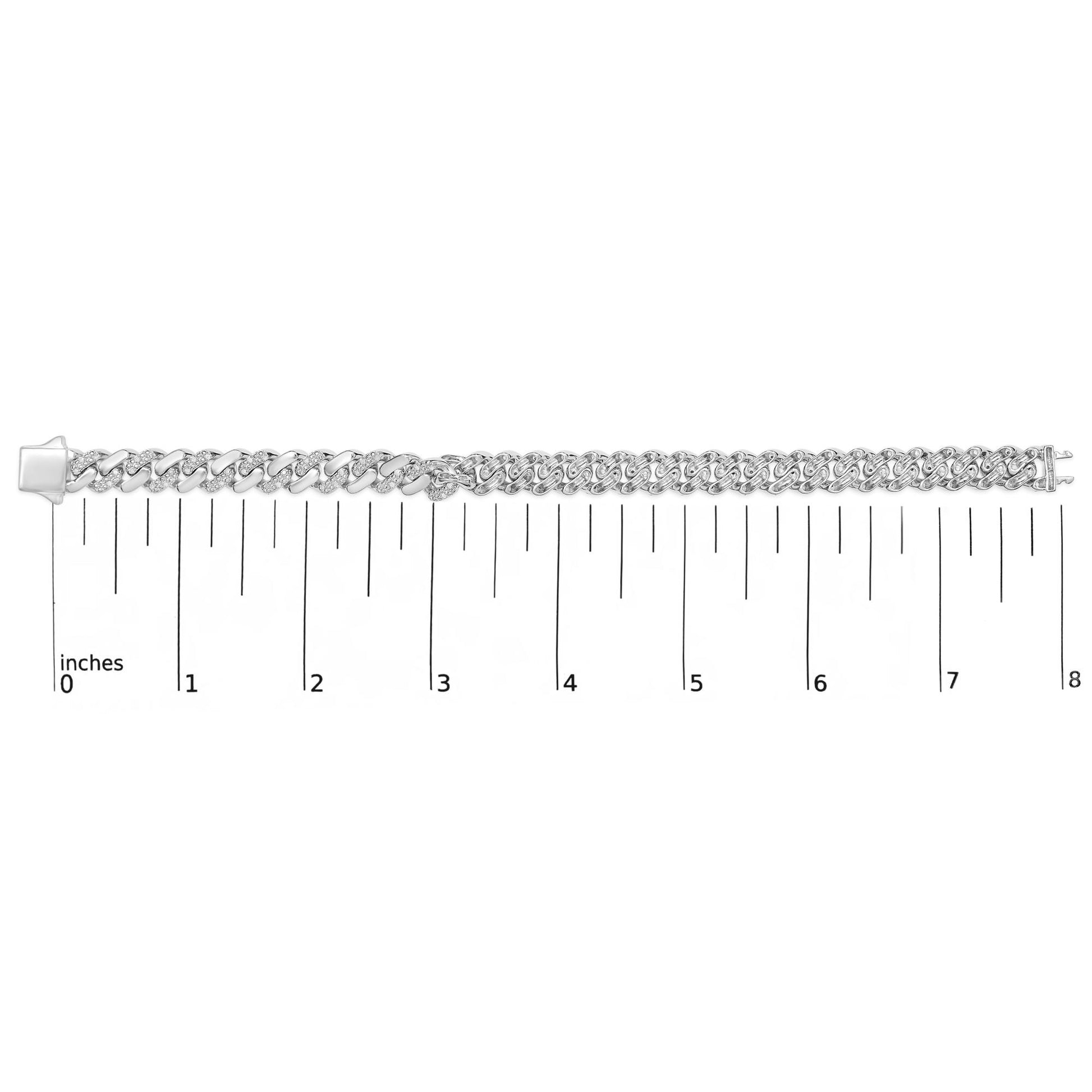 White metal bracelet with two styles of round white gemstones in prong settings along its links, shown in a top-down view on a ruler for size reference.