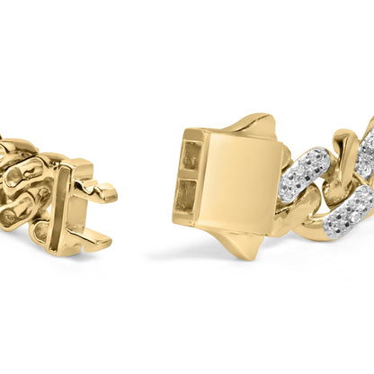 Close-up of a yellow metal bracelet clasp with linked segments, some featuring white round gemstones in prong settings, shot from a side angle.