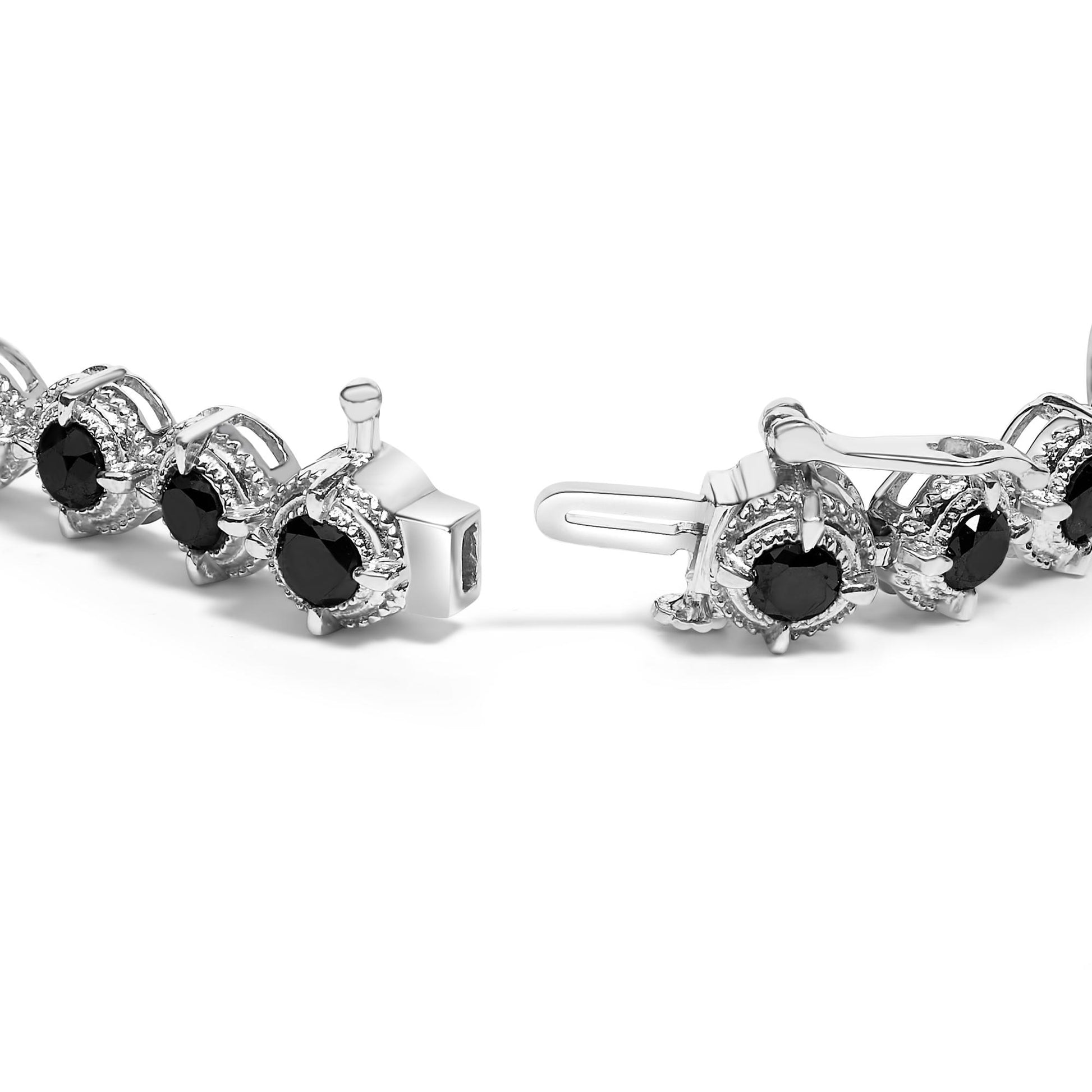 Close-up angle of a white metal bracelet with round black gemstones in prong settings, shown unclasped on a white background.