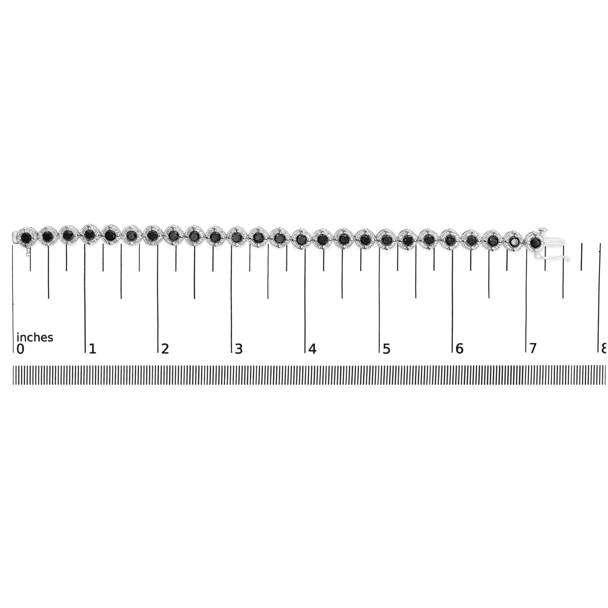 White metal bracelet with alternating round black gemstones in prong settings, shown flat on a measuring scale in a top-down view.