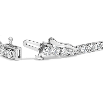 Close-up view of a white metal bracelet with round white gemstones in four-prong settings, showing the clasp mechanism.