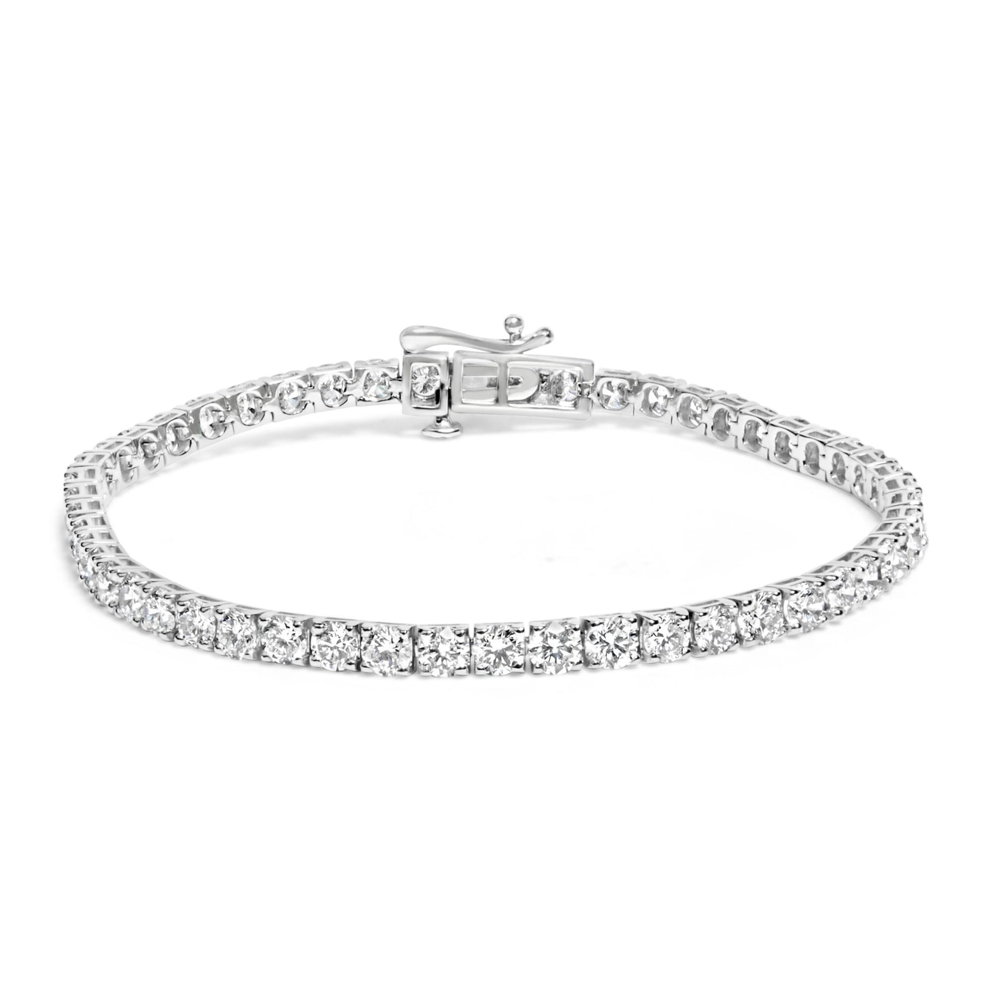 White metal tennis bracelet with round white gemstones in prong settings, shown in a front angled view.