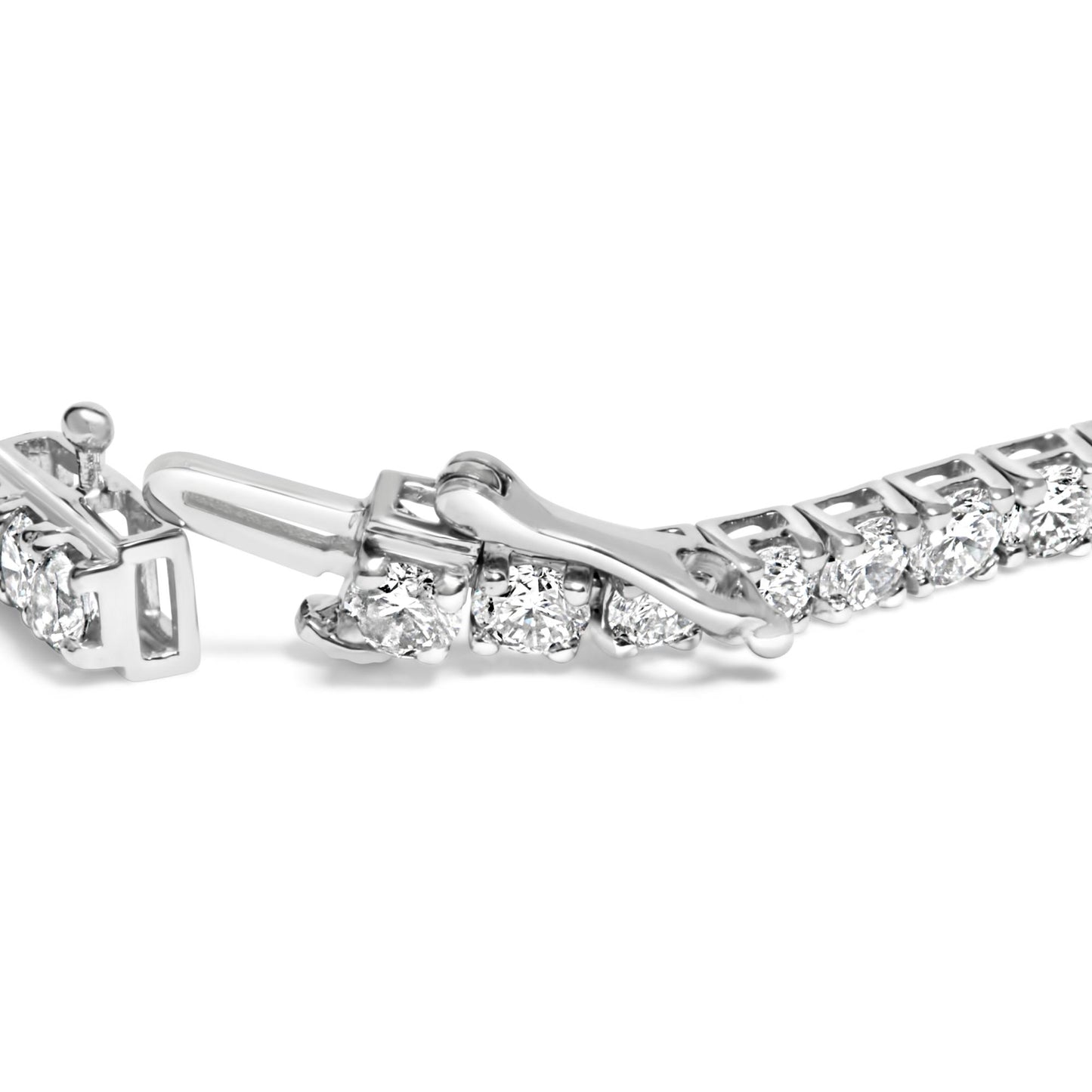 Close-up side angle of a white metal bracelet with round white gemstones in prong settings, featuring an open clasp.
