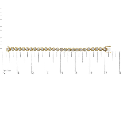 Yellow metal bracelet with round white gemstones in prong settings, shown flat on a scale, photographed from above.