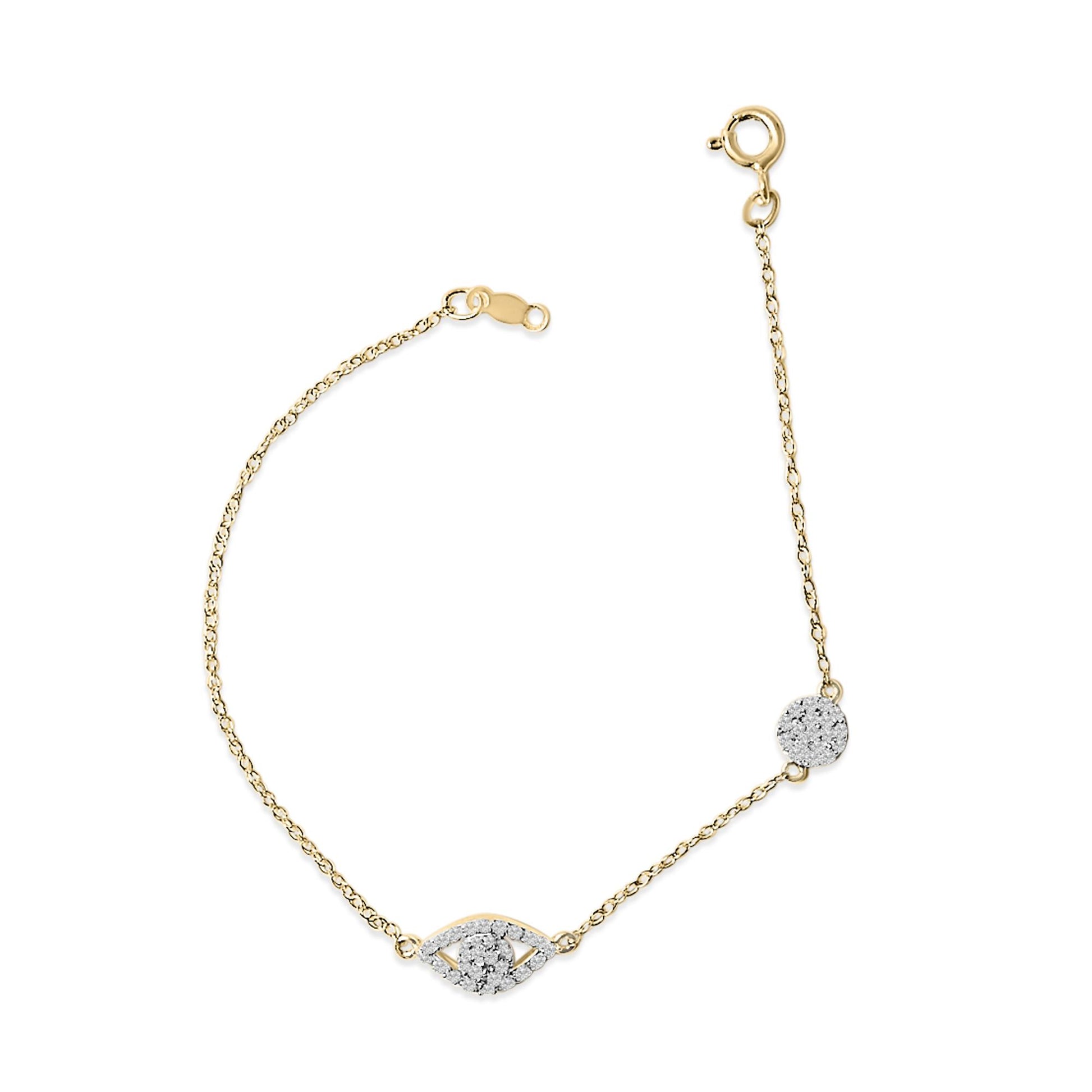 Yellow metal bracelet with white gemstones in round shapes arranged in a central eye and circular motifs, shown from a top-down angle on a white background.