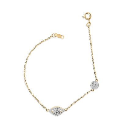 Yellow metal bracelet with white gemstones in round shapes arranged in a central eye and circular motifs, shown from a top-down angle on a white background.