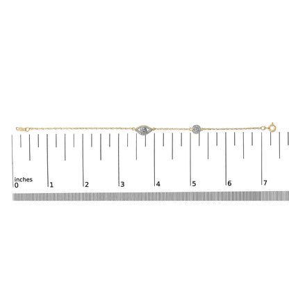 Yellow metal bracelet with two white gemstone clusters, one in an eye shape and one round, shown on a scale in a top-down elevation view.