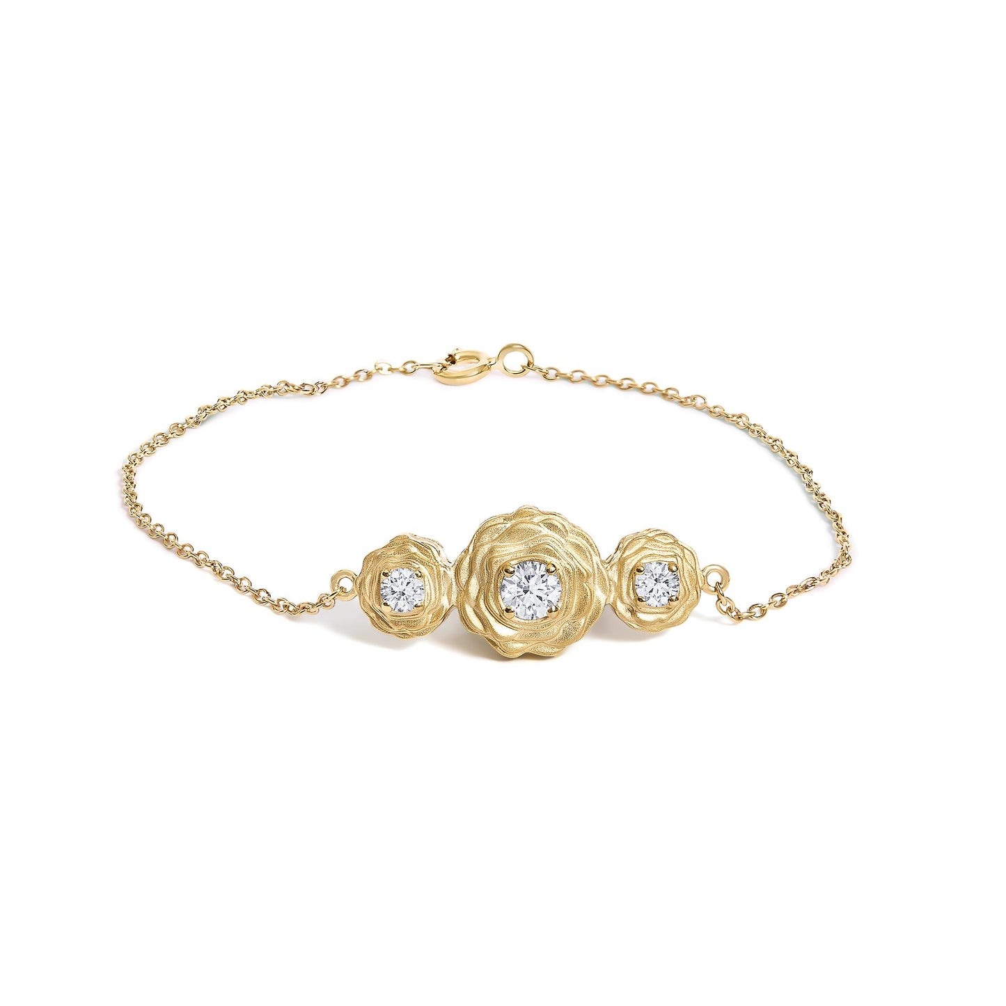 Yellow metal bracelet shown from the top on a white background, featuring three flower-shaped settings with round white gemstones in prong settings, one larger stone in the center and two smaller stones on each side.