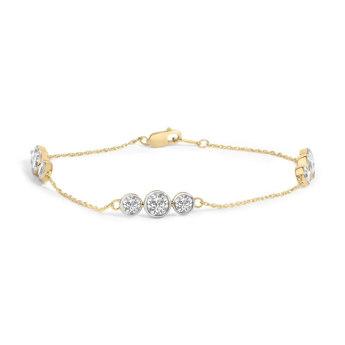Close-up angled shot of a yellow metal bracelet with a chain and clasp, featuring a center element with three white round gemstones in bezel settings.