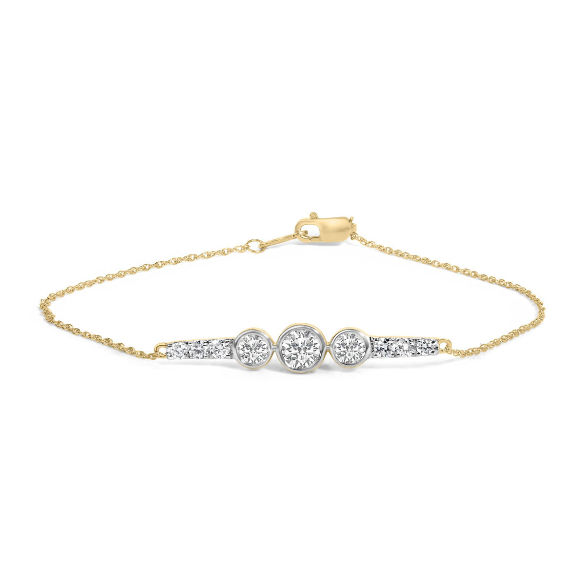 Close-up front angle of a yellow metal bracelet featuring a delicate chain and a central bar adorned with round white gemstones in prong and bezel settings.