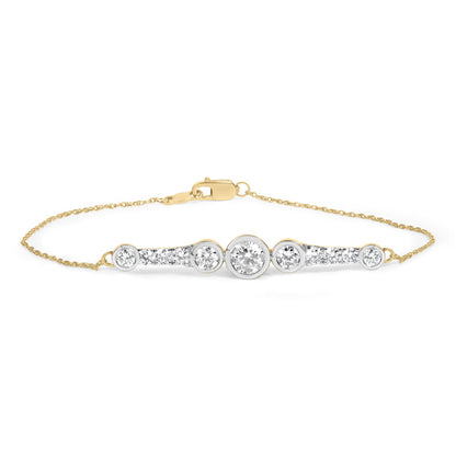 Close-up front view of a yellow bracelet with a delicate chain and a central bar adorned with round white gemstones in prong and bezel settings.
