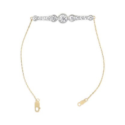 Close-up front view of a yellow metal bracelet with a delicate chain. The bracelet features a central curved bar adorned with multiple round white gemstones in prong and bezel settings, arranged in a symmetrical pattern. The bracelet is shown unfastened against a white background.
