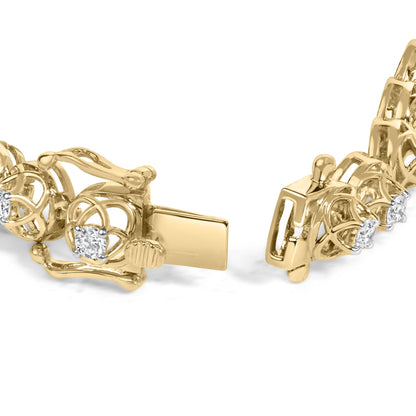 Close-up front angle of a yellow metal bracelet with intricate openwork design and round white gemstones in prong settings.