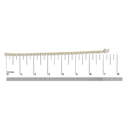 Yellow metal bracelet with round white gemstones in prong settings, shown on a ruler scale from a top-down angle.