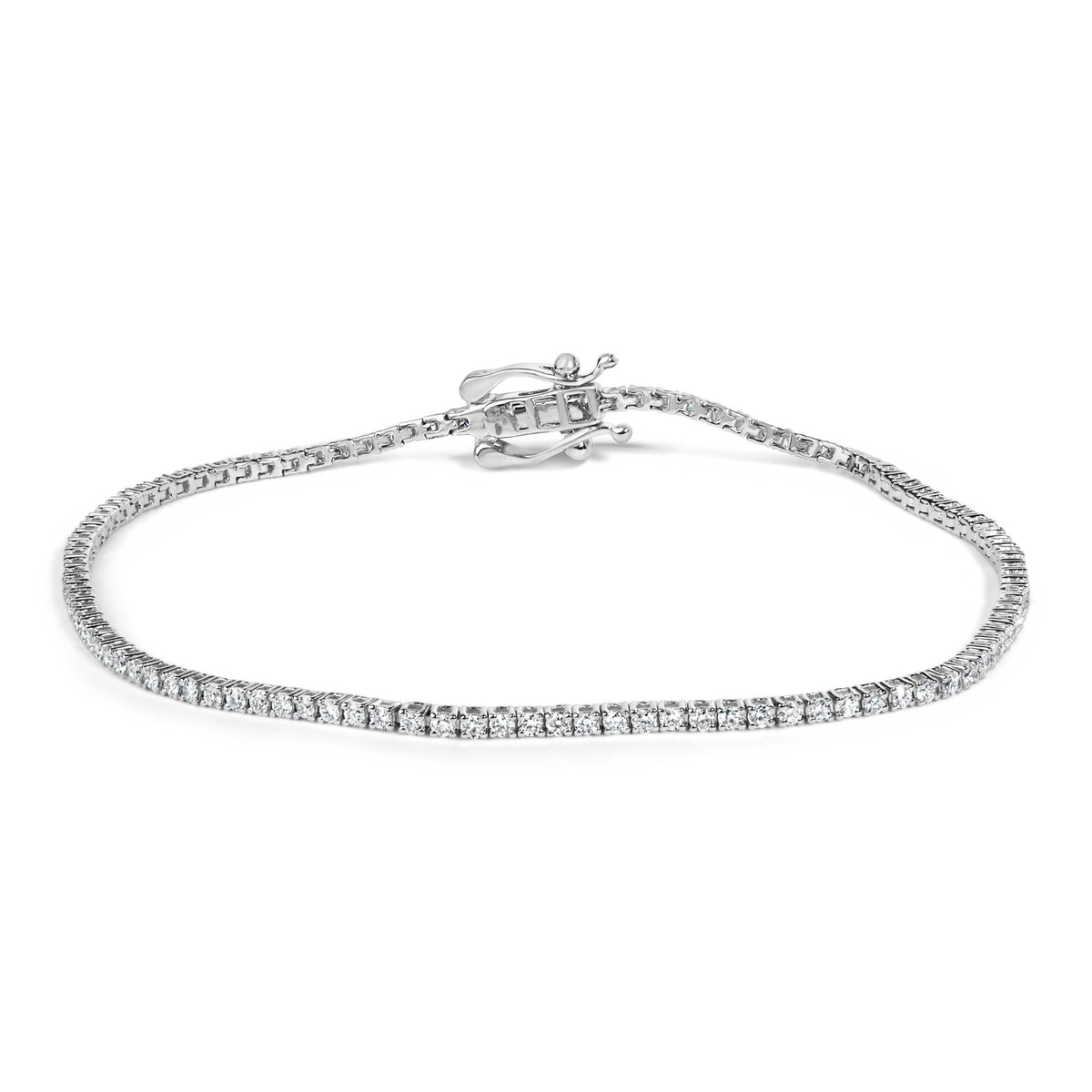 Close-up angle of a white metal tennis bracelet with round white gemstones in prong settings and a decorative clasp, shown on a white background.