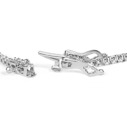 Close-up side angle of a white bracelet with round white gemstones in prong settings, showing the clasp mechanism.