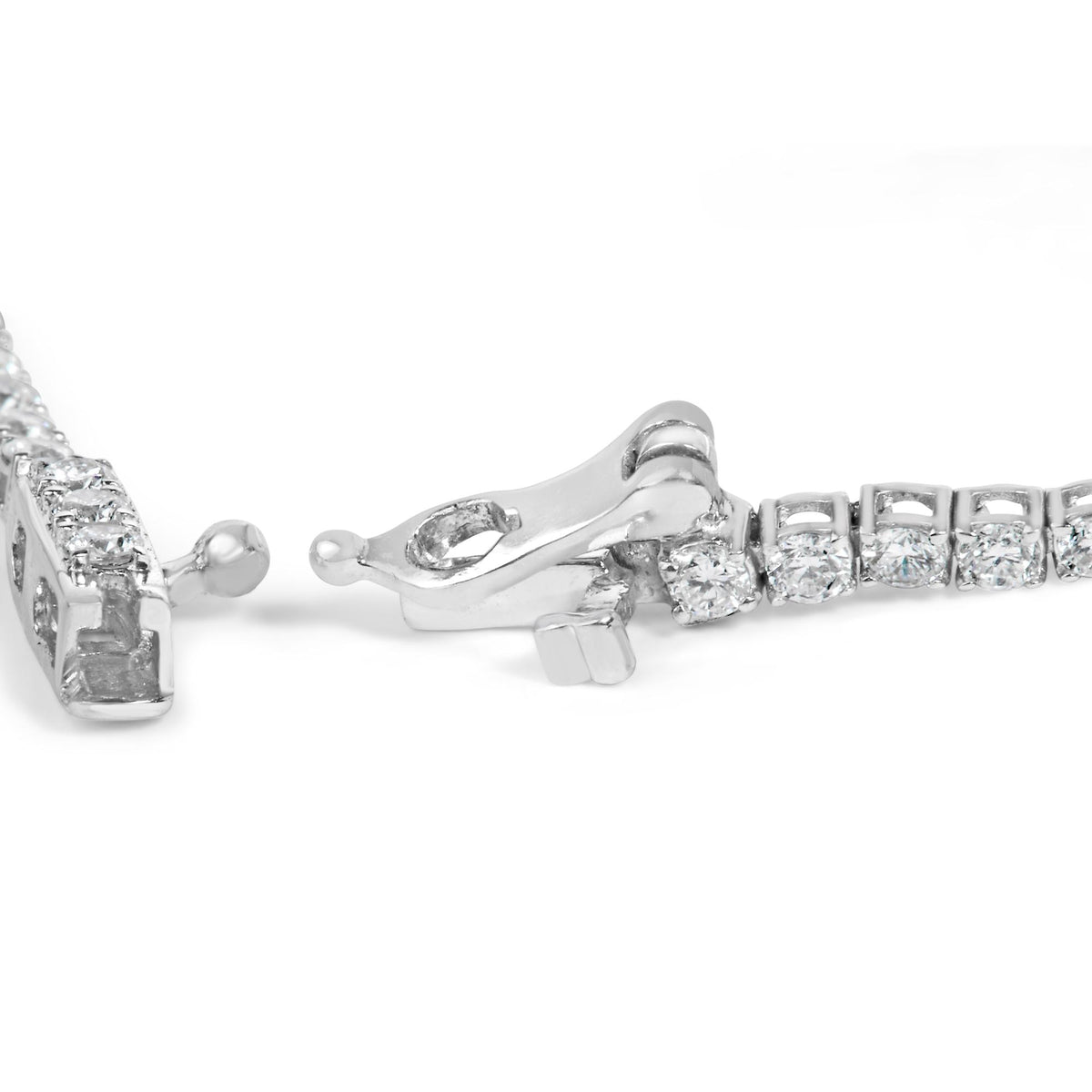 Close-up image of a white metal bracelet clasp set with round white gemstones in prong settings, shot from an angled side view on a white background.