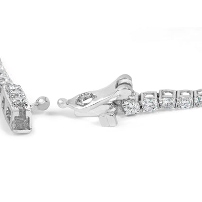 Close-up image of a white metal bracelet clasp set with round white gemstones in prong settings, shot from an angled side view on a white background.
