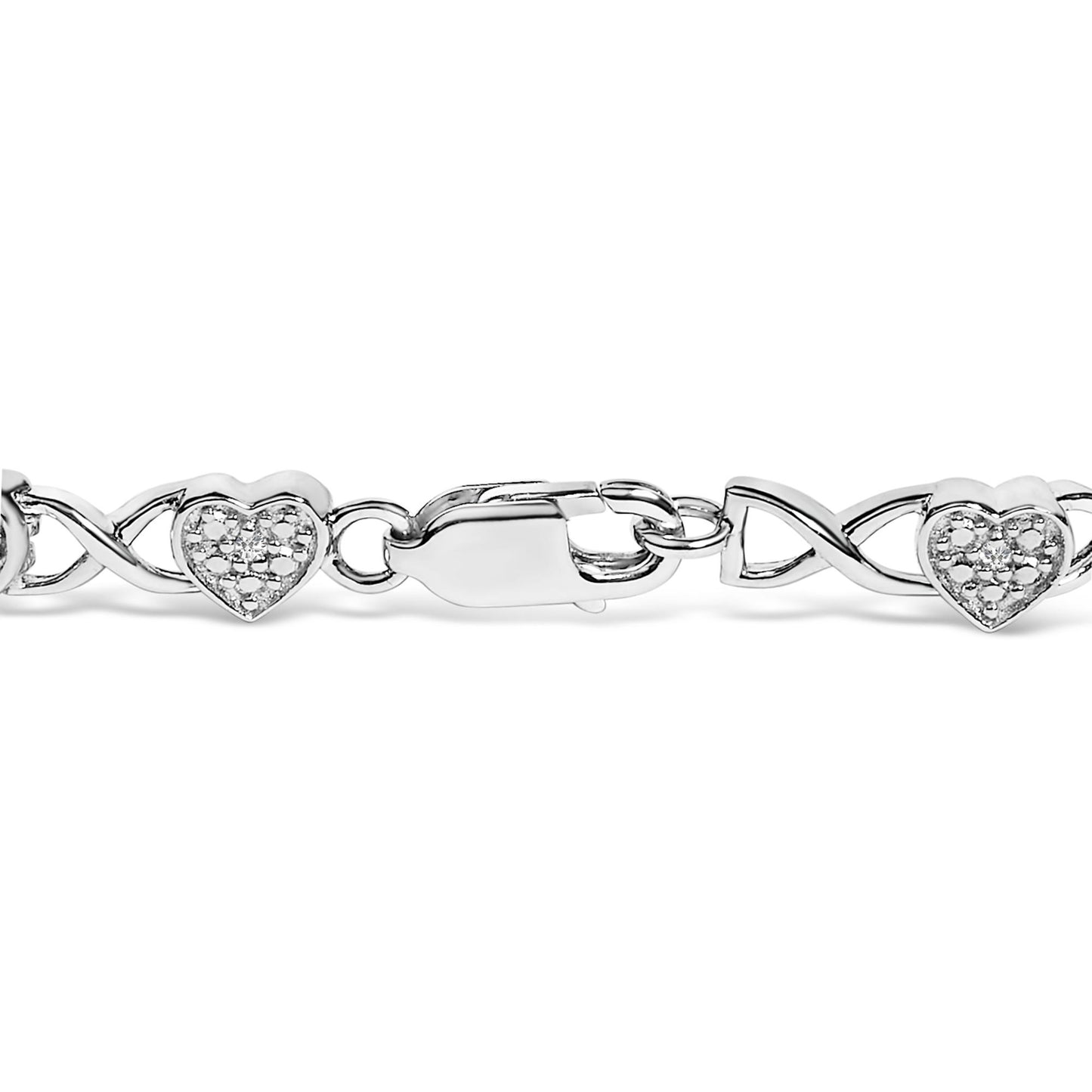 Close-up front view of a white metal bracelet with heart-shaped sections set with small white gemstones and a lobster clasp closure.