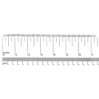 White metal bracelet with heart-shaped links each set with multiple small white gemstones, shown flat on a ruler for size reference, top-down view.