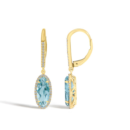 Close-up front and side view of yellow earrings with oval blue gemstones surrounded by small white gemstones, shown on a white background.