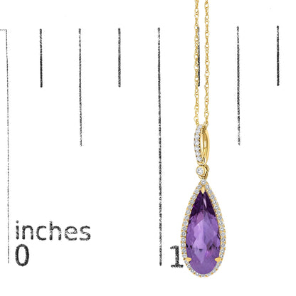 Close-up front angle of a yellow metal necklace shown on a scale, featuring a pear-shaped purple gemstone surrounded by small white gemstones in a micro-pave setting.