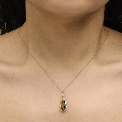Close-up front view of a 10K yellow gold shield-shaped citrine and 1/5 cttw diamond halo pendant necklace on a model