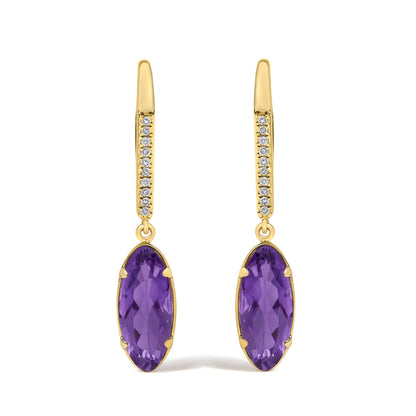 Close-up front view of yellow metal drop earrings with oval purple gemstones in prong settings and vertical rows of round white gemstones in micro-pave settings.