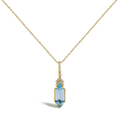 Close-up front view of a yellow metal necklace with a pendant featuring multiple small white gemstones in micro-pave setting and one large blue gemstone in a prong setting.