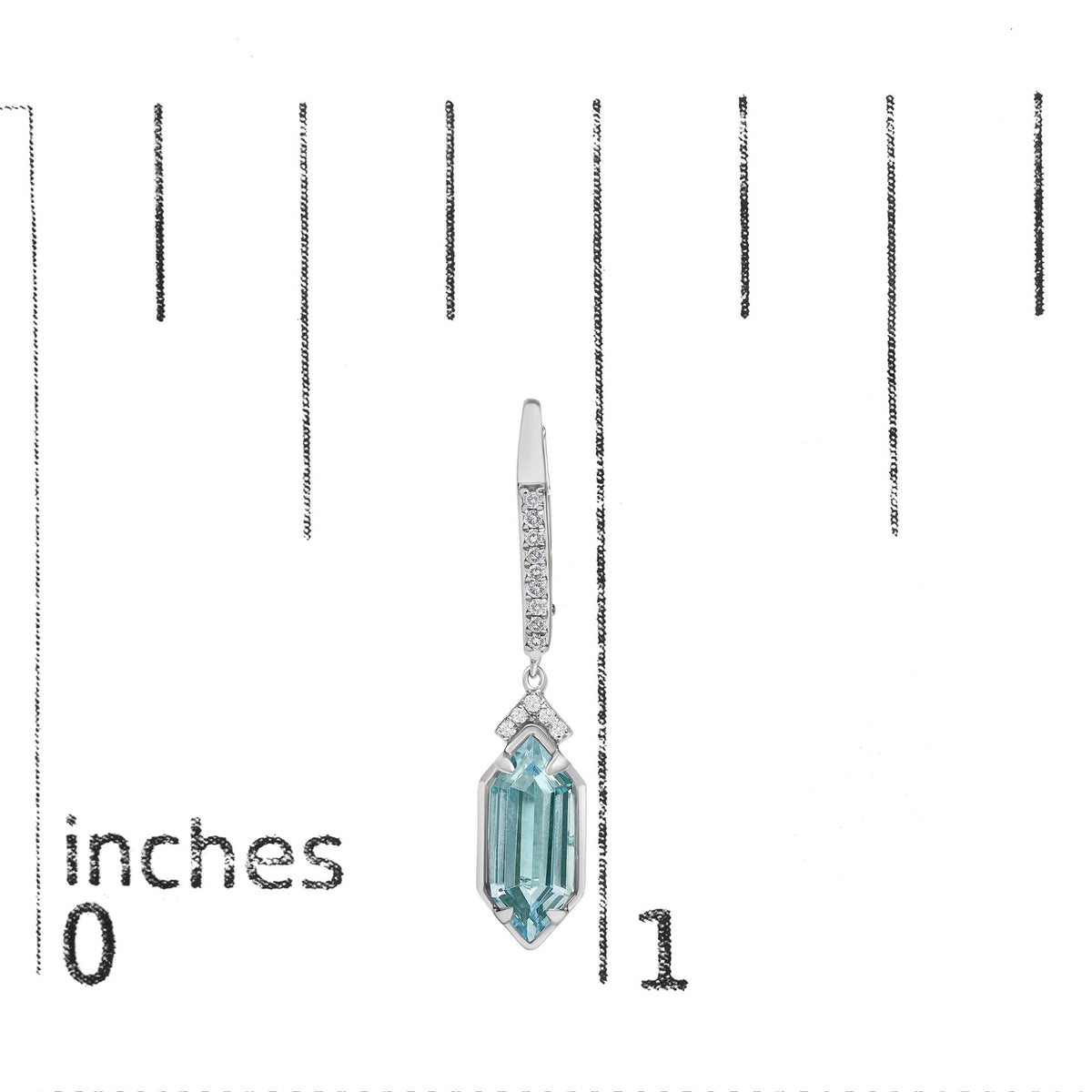 Close-up front view of yellow metal dangling earring with round white gemstones in micro-pave setting, two small purple gemstones in prong setting, and a larger blue gemstone at the bottom, shown on a scale.