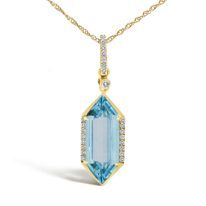 Close-up front view of a yellow metal necklace with a vertically aligned pendant featuring round white gemstones in micro-pave setting along the top and sides, and a large blue gemstone in a prong setting at the bottom.