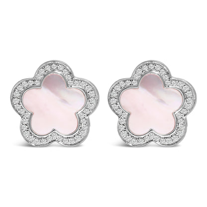 Front view of a pair of white metal flower-shaped stud earrings with central white mother of pearl gemstones in bezel settings, surrounded by micro-pave set round white gemstones.