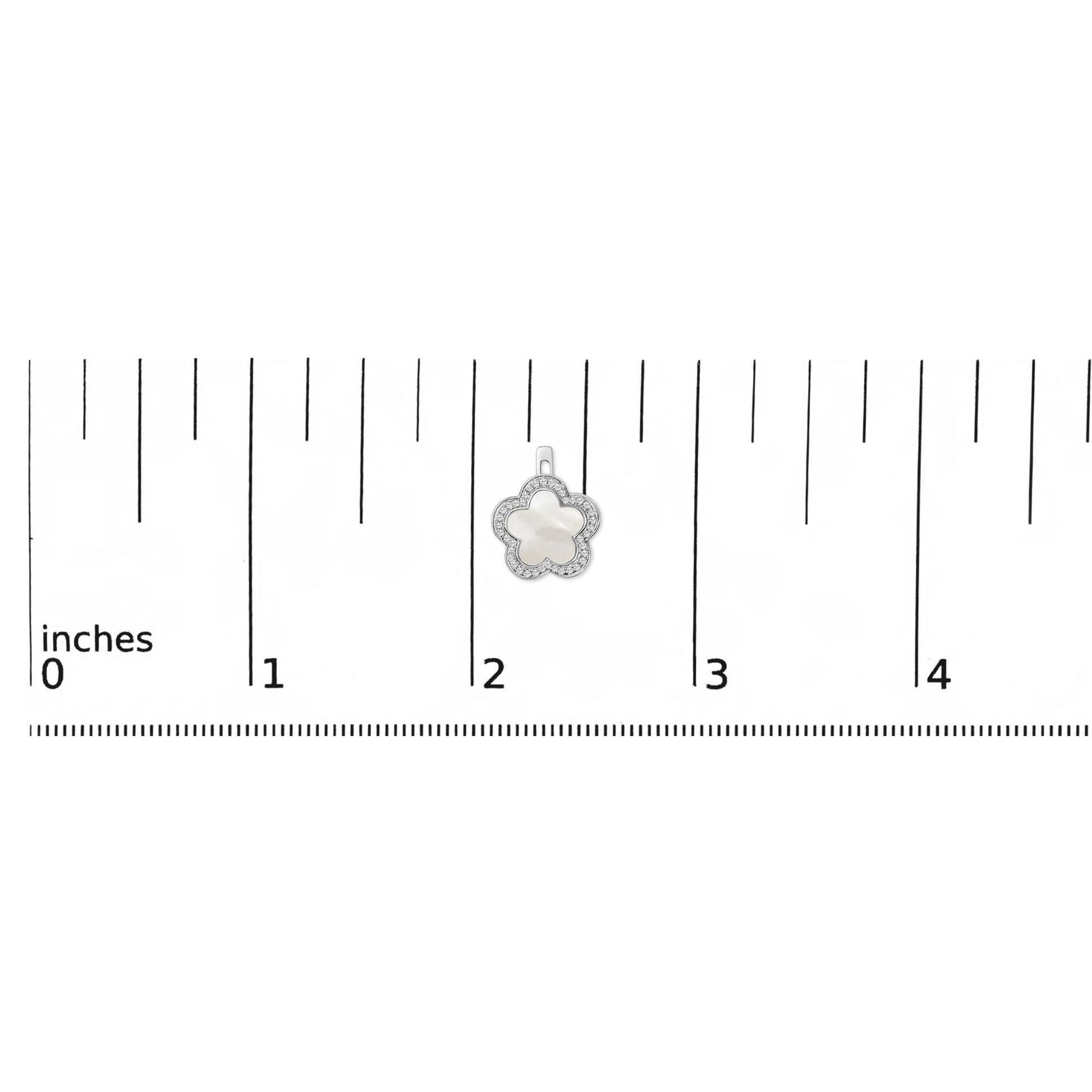 White metal flower-shaped earring with white mother of pearl center and micro-pave white gemstones around the edge, shown on a scale.