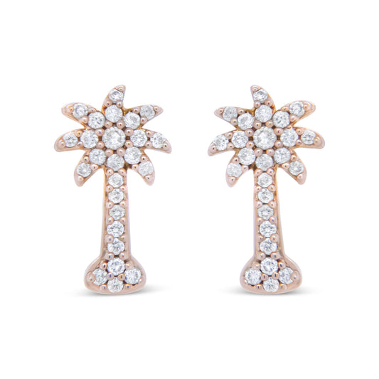 Front view of rose metal earrings shaped like stylized palm trees, adorned with round white gemstones in prong settings.