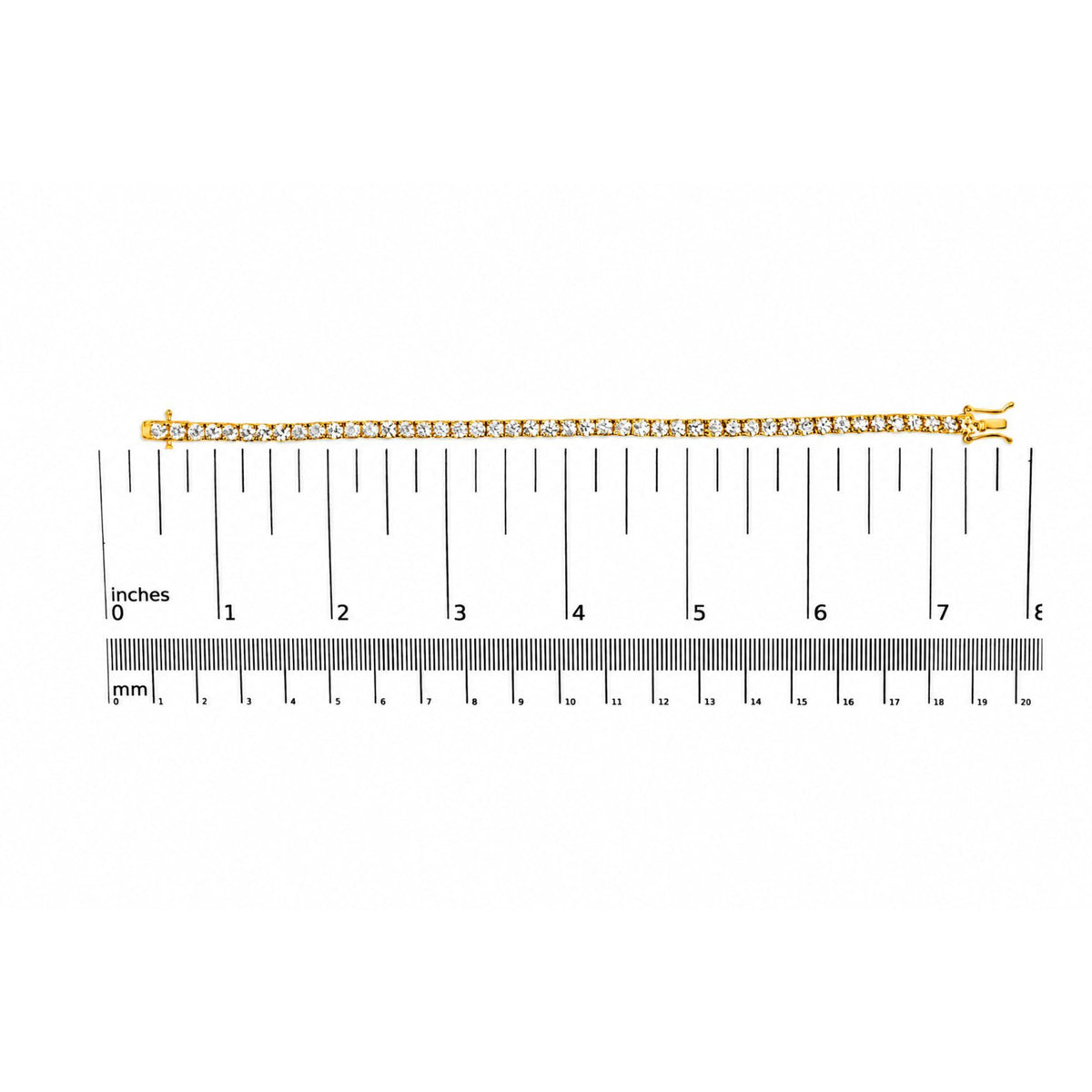 Yellow bracelet with round white gemstones in 4-prong settings, shown flat on a ruler scale, photographed from above.