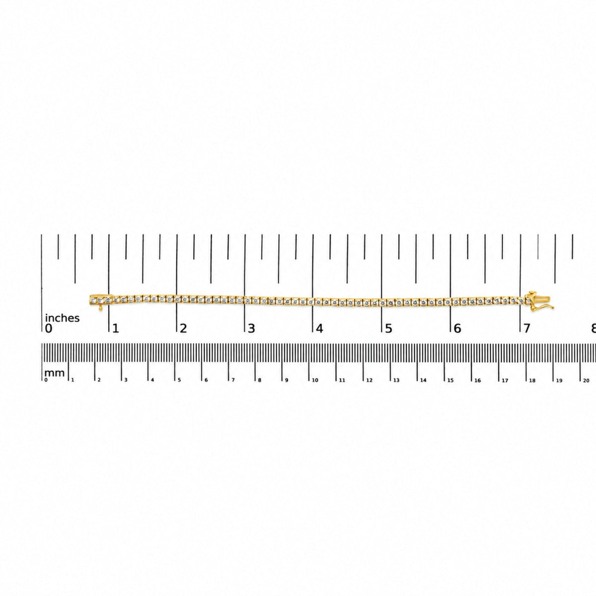 Close-up image of a yellow metal bracelet with two rows of round white gemstones set in 4-prong settings, displayed flat on a measurement scale with inches and millimeters, shot from above.