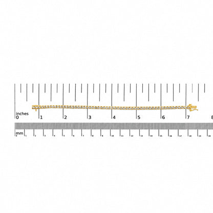 Close-up image of a yellow metal bracelet with two rows of round white gemstones set in 4-prong settings, displayed flat on a measurement scale with inches and millimeters, shot from above.