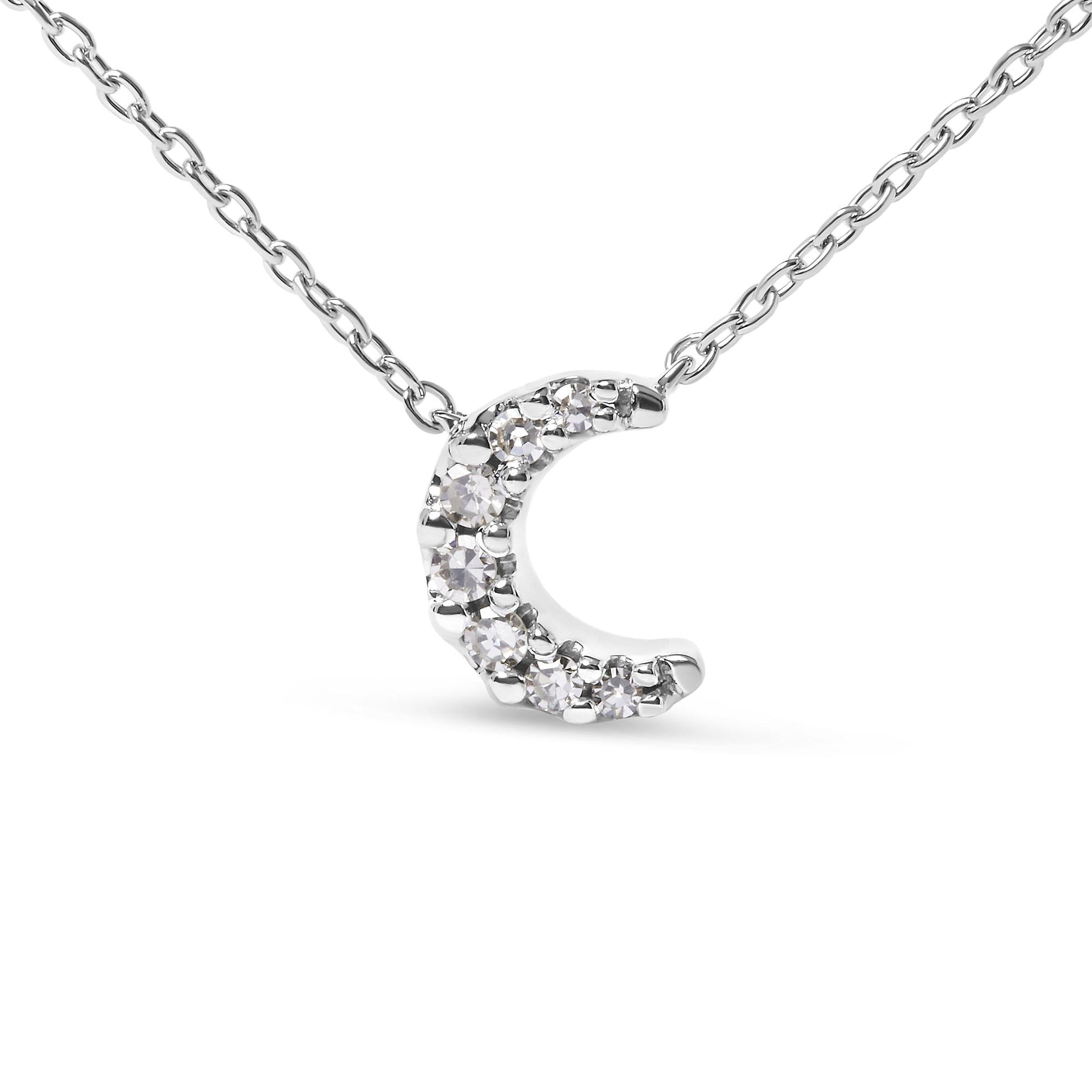 Close-up front view of a white metal necklace with a crescent-shaped pendant featuring round white gemstones in pave setting.