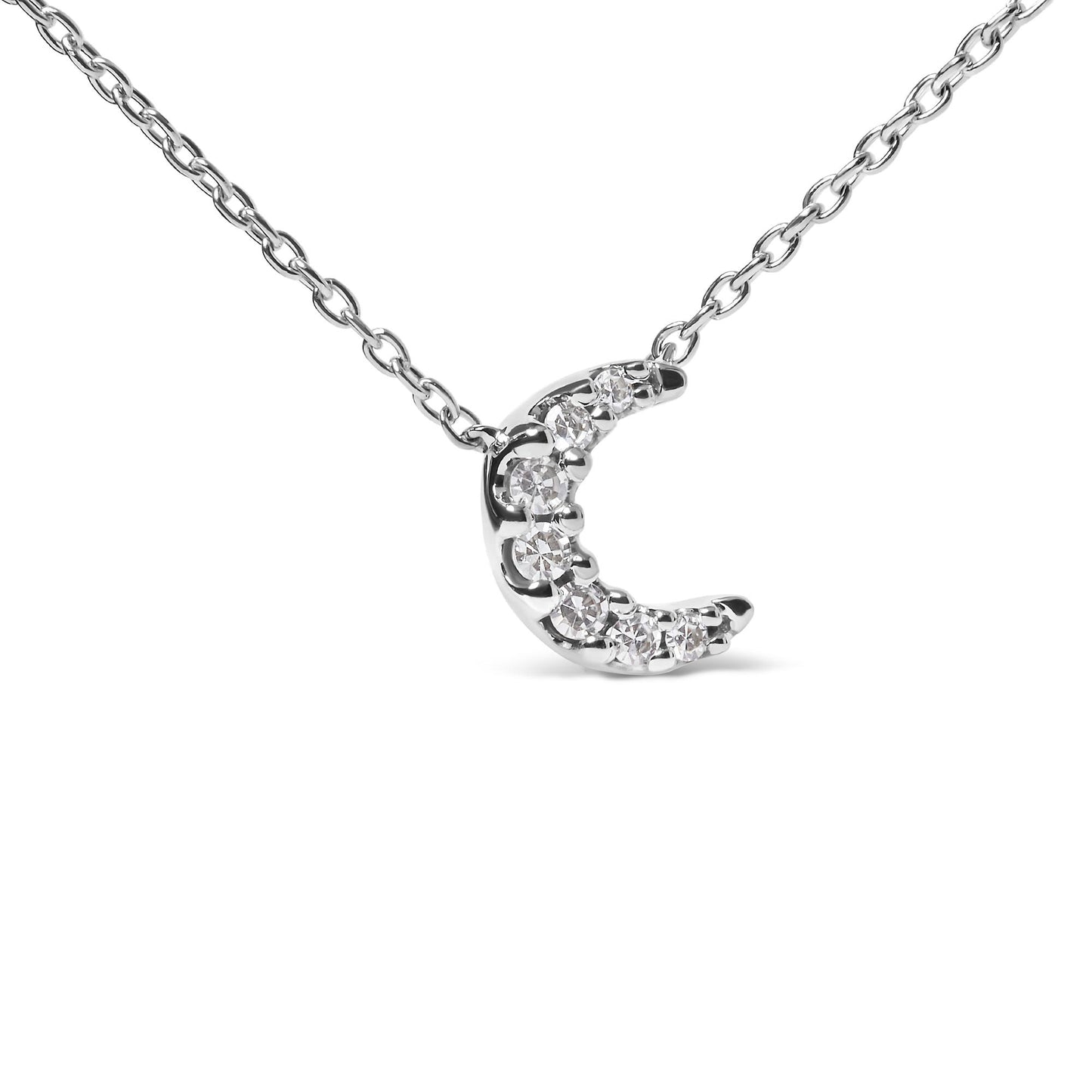 Close-up front angled view of a white metal crescent moon-shaped necklace pendant with round white gemstones in pave setting, on a white metal chain.