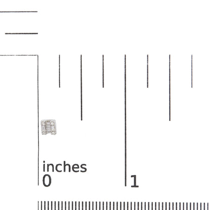 Close-up front view of a white metal earring with a geometric design featuring baguette and round white gemstones, shown on a ruler for size reference.