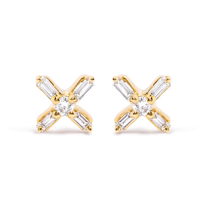 Front angle view of yellow metal earrings with a central round white gemstone and four surrounding baguette-shaped white gemstones in prong settings.