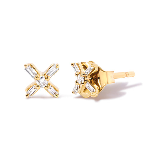 Close-up front and side view of yellow metal earrings with a cross design featuring white round and baguette-shaped gemstones in prong settings.