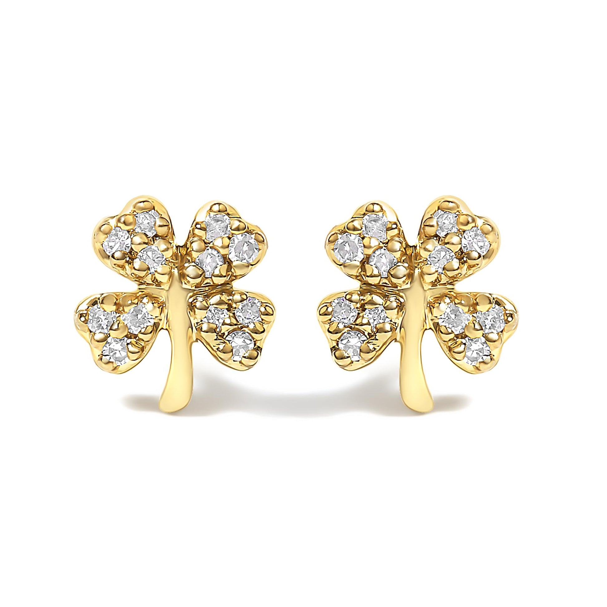 Front view of a pair of yellow metal earrings shaped like four-leaf clovers, each leaf embedded with multiple white round gemstones in prong settings.