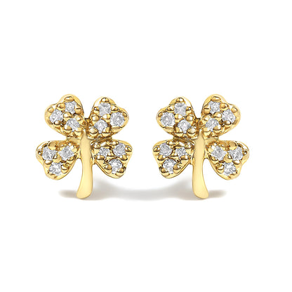Front view of a pair of yellow metal earrings shaped like four-leaf clovers, each leaf embedded with multiple white round gemstones in prong settings.