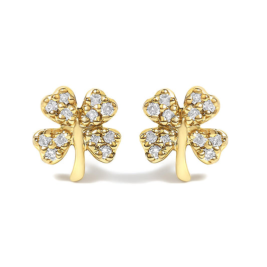 Front view of a pair of yellow metal earrings shaped like four-leaf clovers, each leaf embedded with multiple white round gemstones in prong settings.