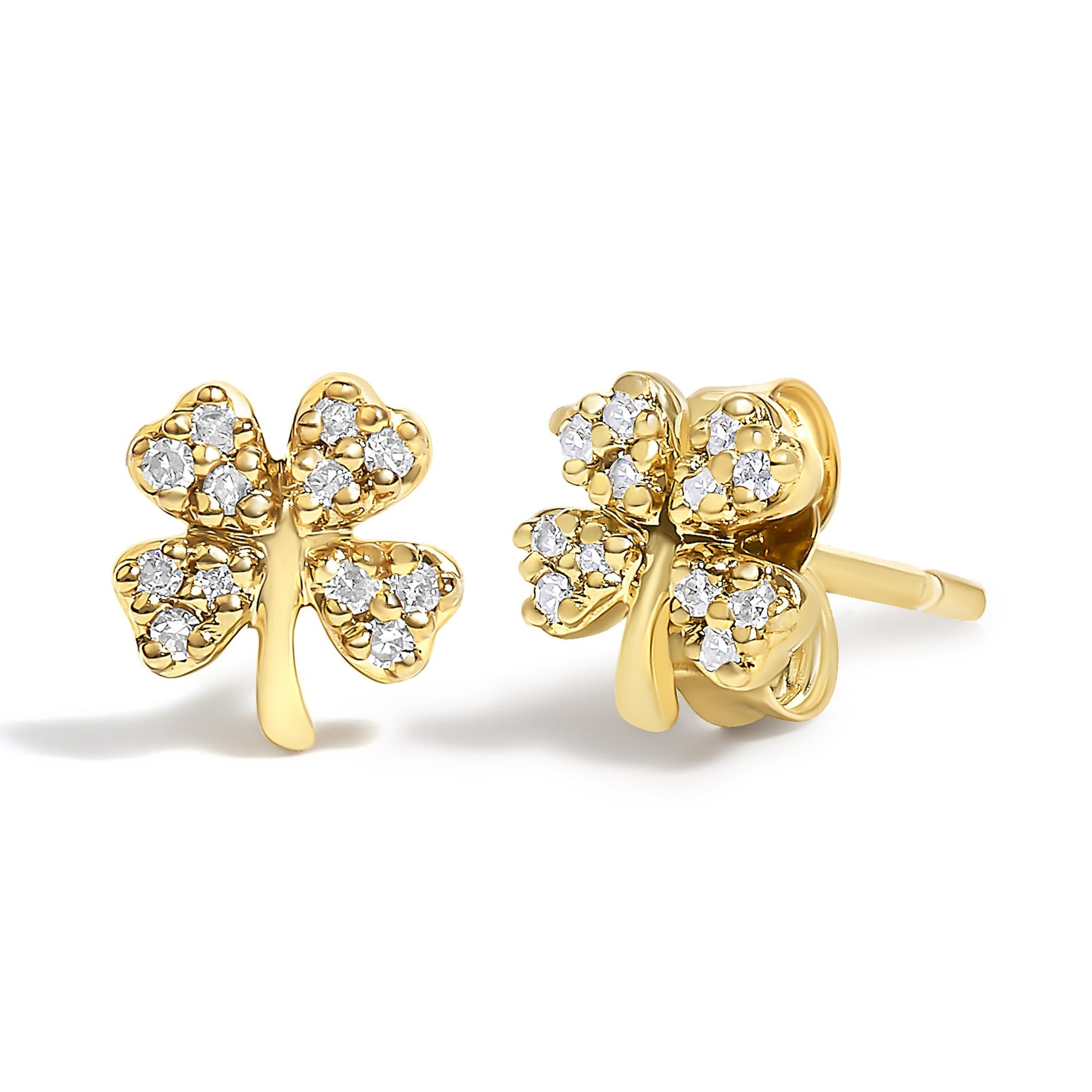Close-up front and side view of yellow metal earrings shaped like four-leaf clovers, each leaf studded with multiple round white gemstones in prong settings.