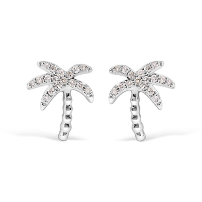 Front angle view of white metal earrings designed as palm trees with round white gemstones in pave setting on the leaves.